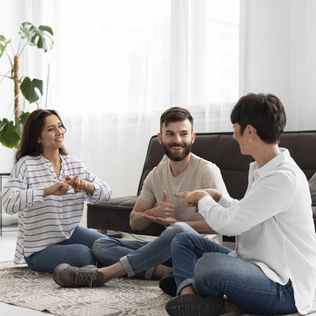 Three adults talking together in a relaxed group conversation